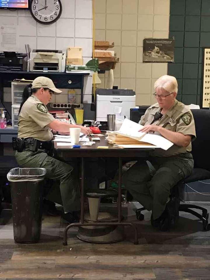 Two correctional officer working at a table