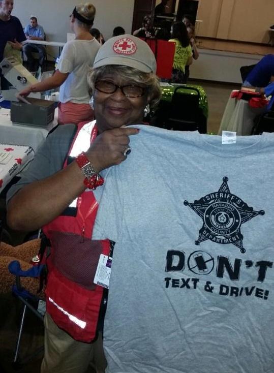 Woman holding a don't text and drive shirt