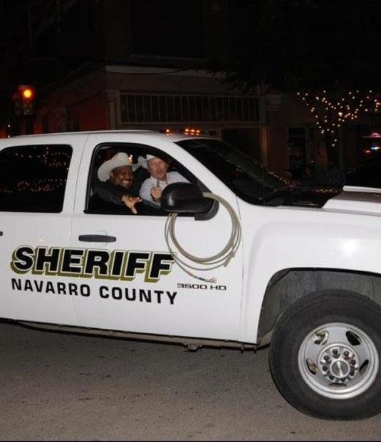 Navarro County Sheriffs Officers in vehicle participating in Corsicana Christmas Parade