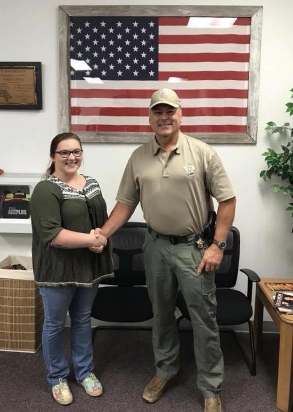 Myriah Rollins shakes Sheriff Tanners hand