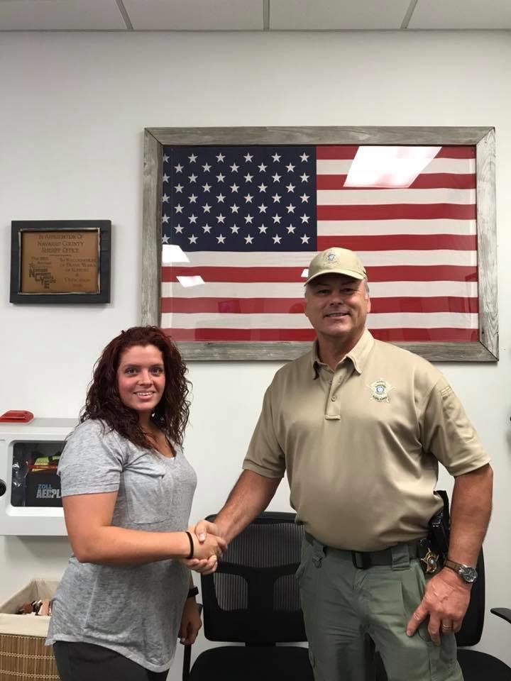 Lauren Reese shakes Sheriff Tanner's hand