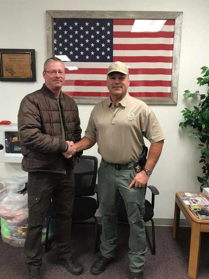 Deputy Randy Nanny shakes Sheriff Tanner's hand