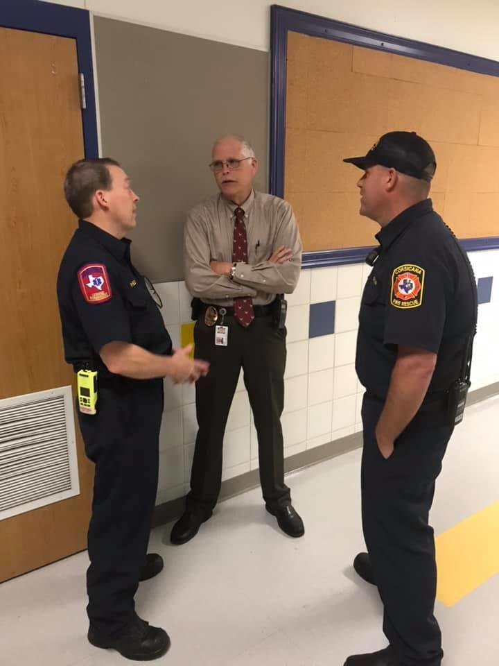 Officials talking in hallway