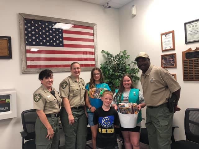 office staff posing with girl scouts