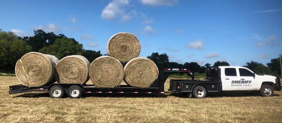 Truck with hay bales behind it