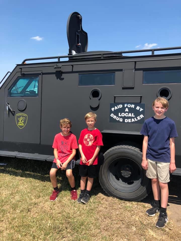 3 children in front of the armored vehicle
