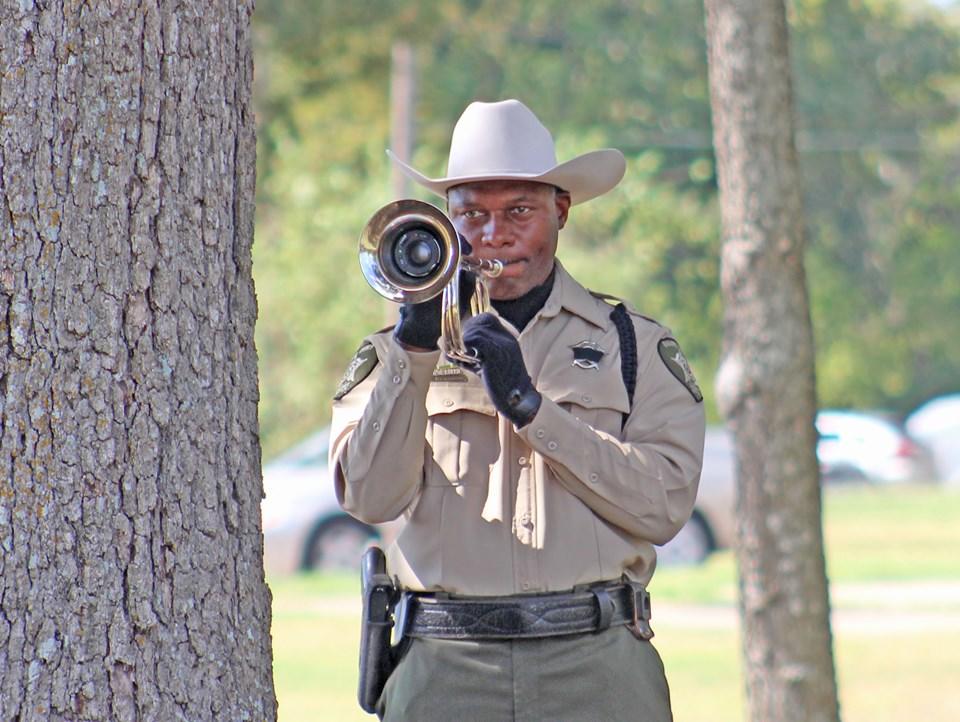 Officer blowing a bugle