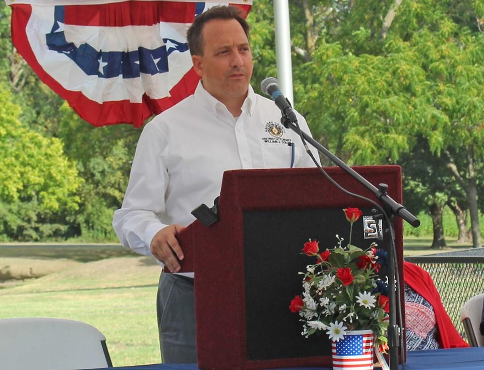 man at podium giving speech