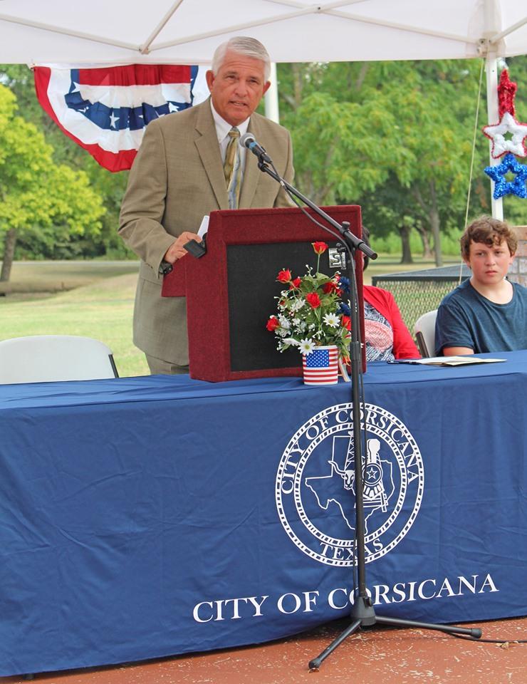 A gentleman wearing a suit at the podium