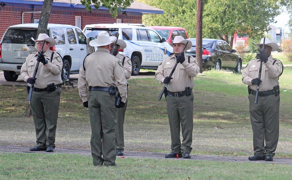 Officers with their rifles giving a salute