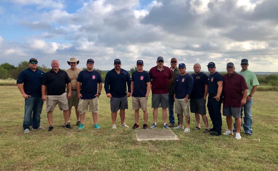 a group of skeet shooters pose