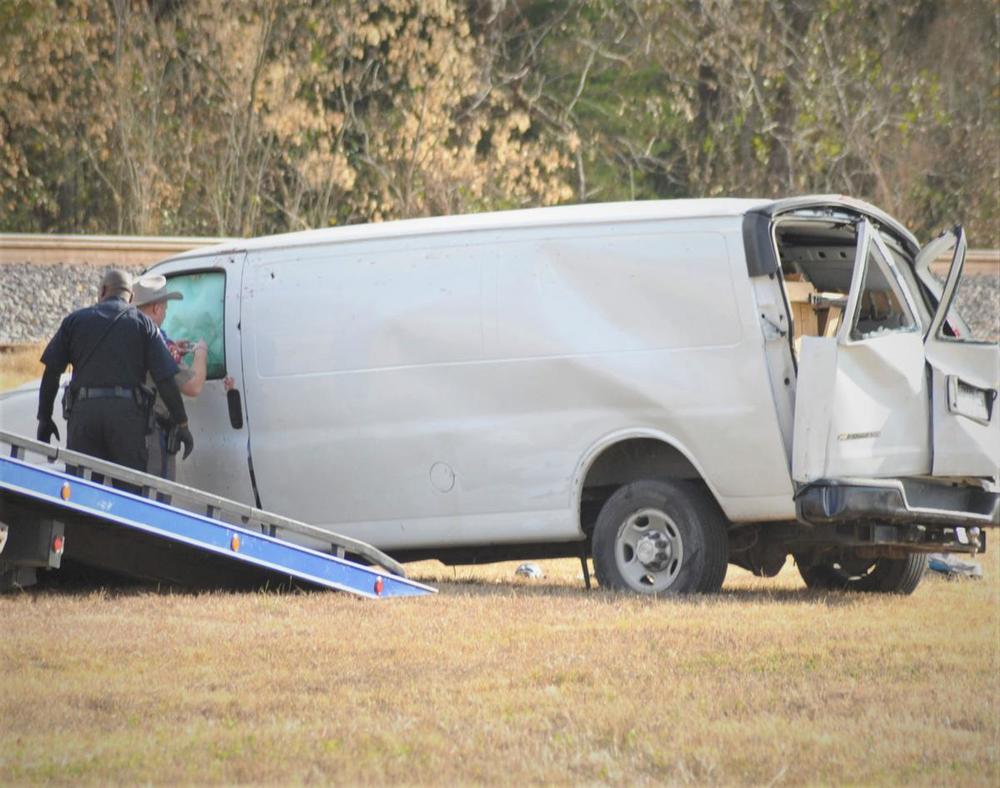 deputies on the crime scene showing a wrecked commercial van