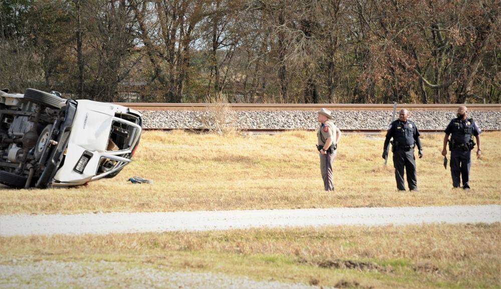 deputies on the crime scene showing a wrecked commercial van