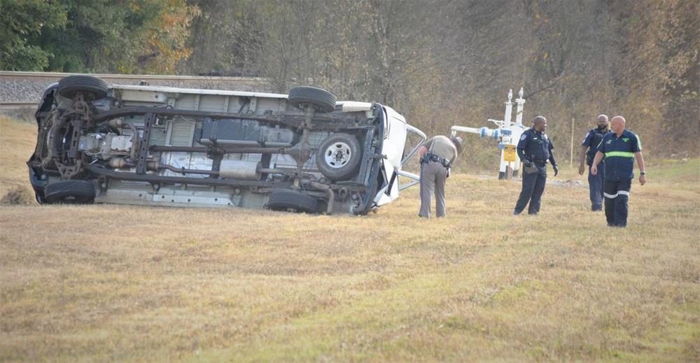 deputies on the crime scene showing a wrecked commercial van