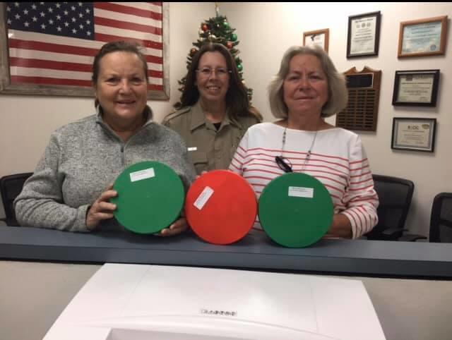 deputy with citizen posing with holiday baskets