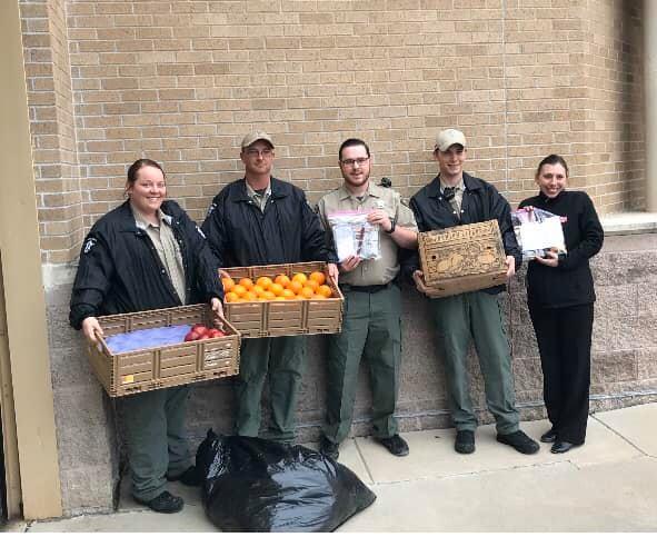 office staff holding donated care packages for inmates