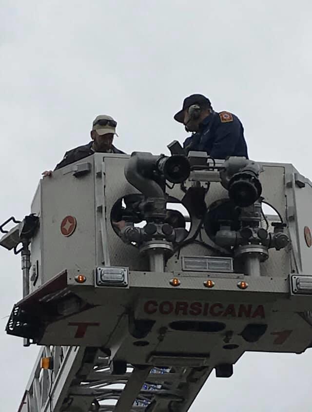 Officers in the bucket of the fire truck