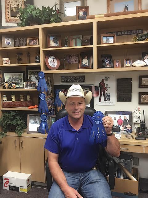 Sheriff Tanner  holding a 2016 Best of the Best County Law Enforcement Officer ribbon