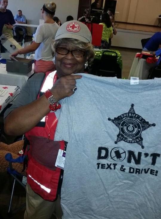 woman holding a dont text and drive shirt