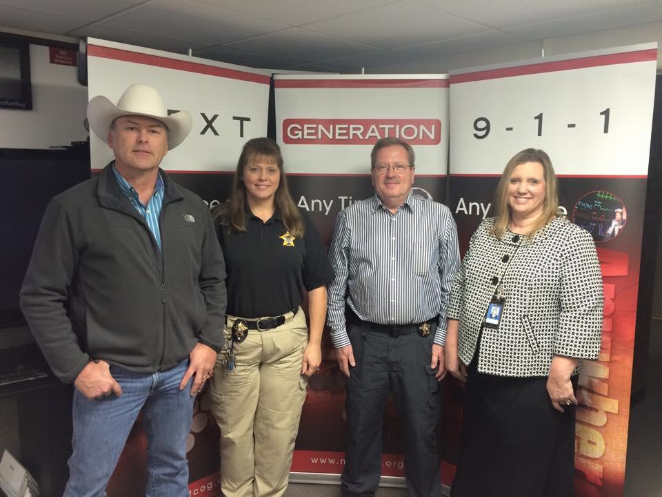 Sheriff Elmer Tanner stands with Sergeant Melanie Cagle, Captain Brett Latta and 9-1-1 Program Director from North Central Texas Council of Government