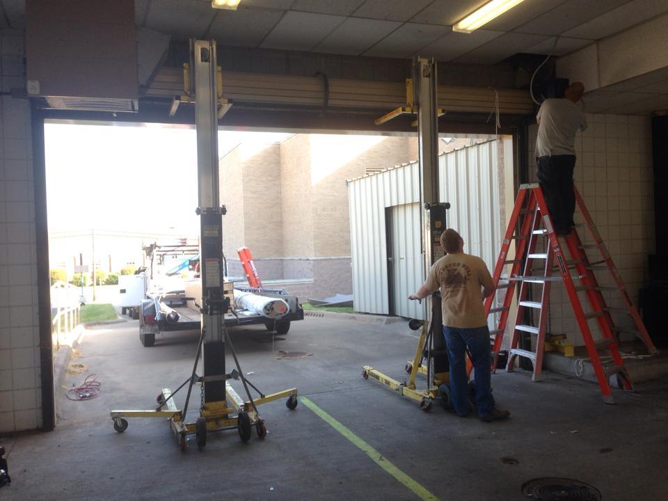  Contractors are installing a new overhead door 