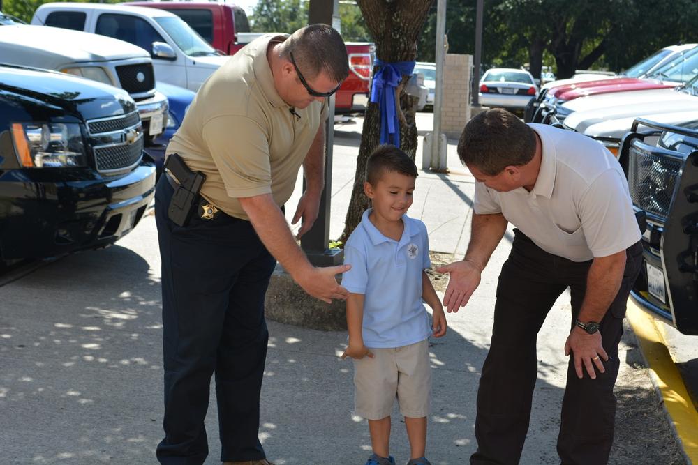 Eli Clagett shaking deputy's hands