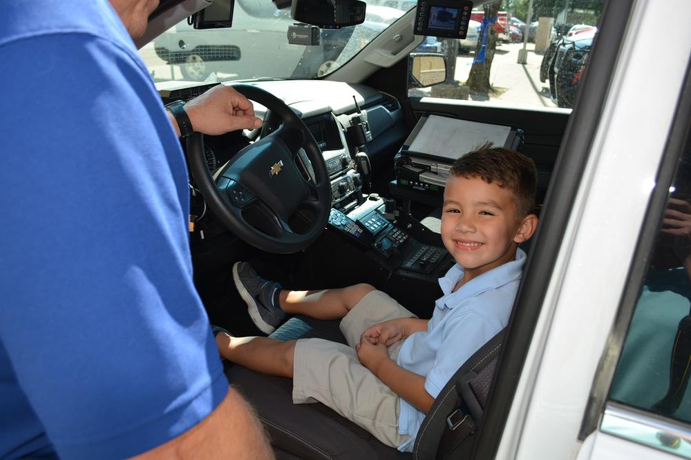 Eli Clagett sitting in a patrol car