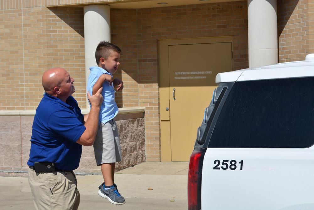 Eli Clagett  being held up by an officer