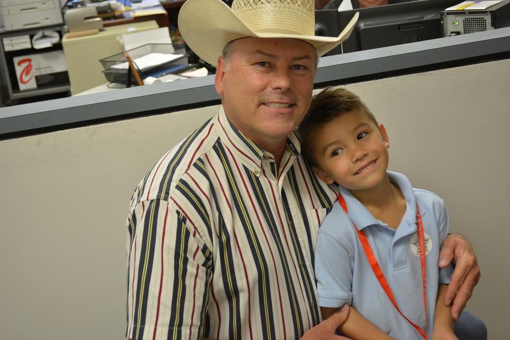 Eli Clagett sitting on an officer's lap