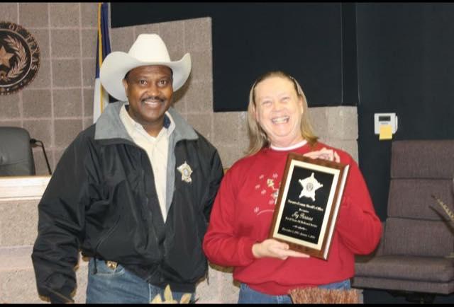 Joy Parsons receives a plaque after 20 years of dedicated service 