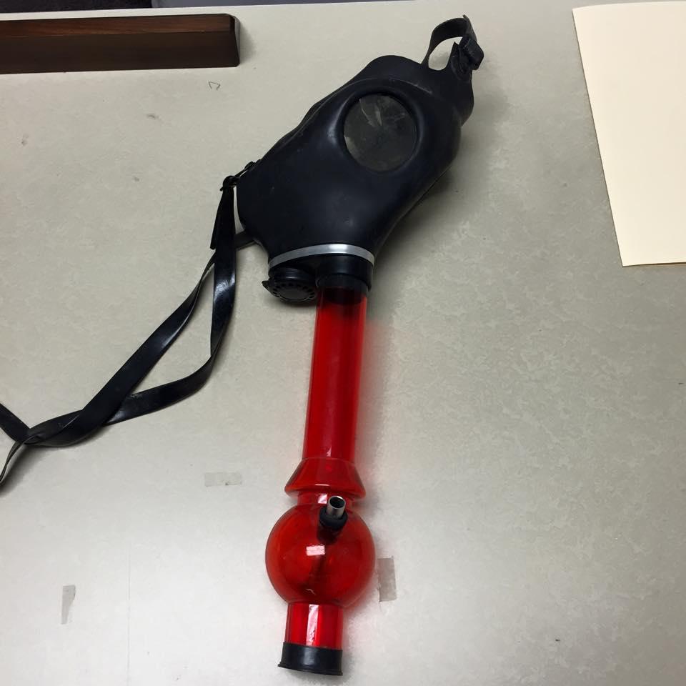 A gas mask with a water bong attachment 