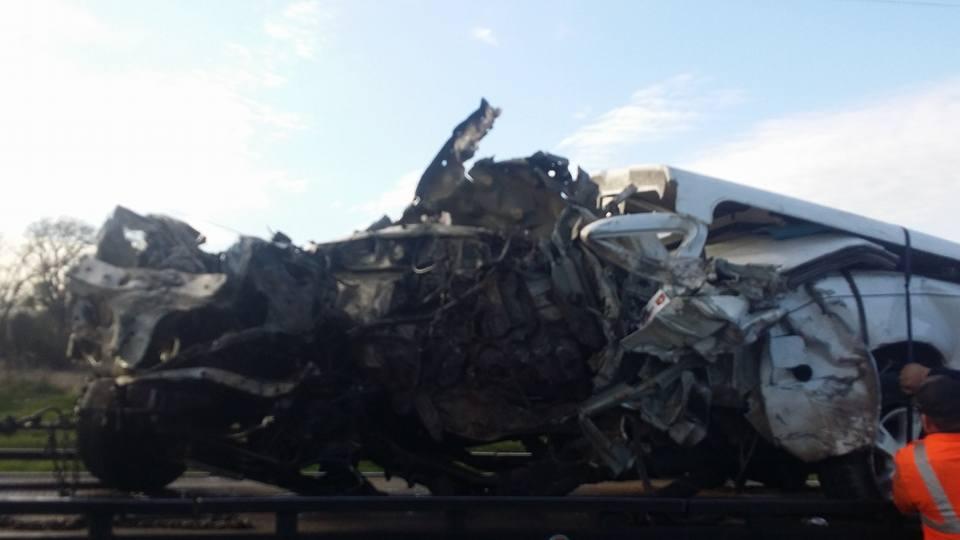 Damage done to a small pickup truck after a head-on collision with a semi-truck