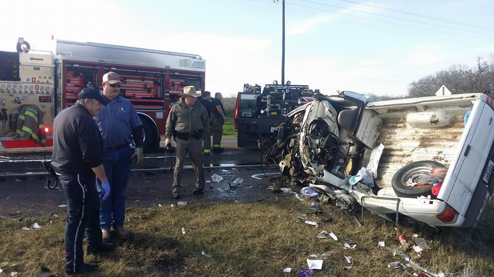 Damage done to a small pickup truck after a head-on collision with a semi-truck