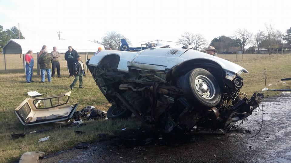 Damage done to a small pickup truck after a head-on collision with a semi-truck