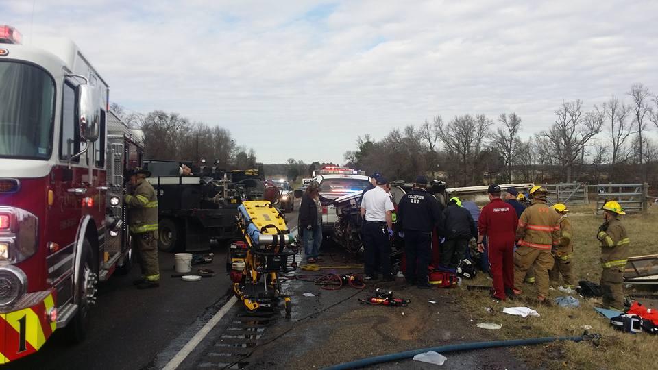 Damage done to a small pickup truck after a head-on collision with a semi-truck