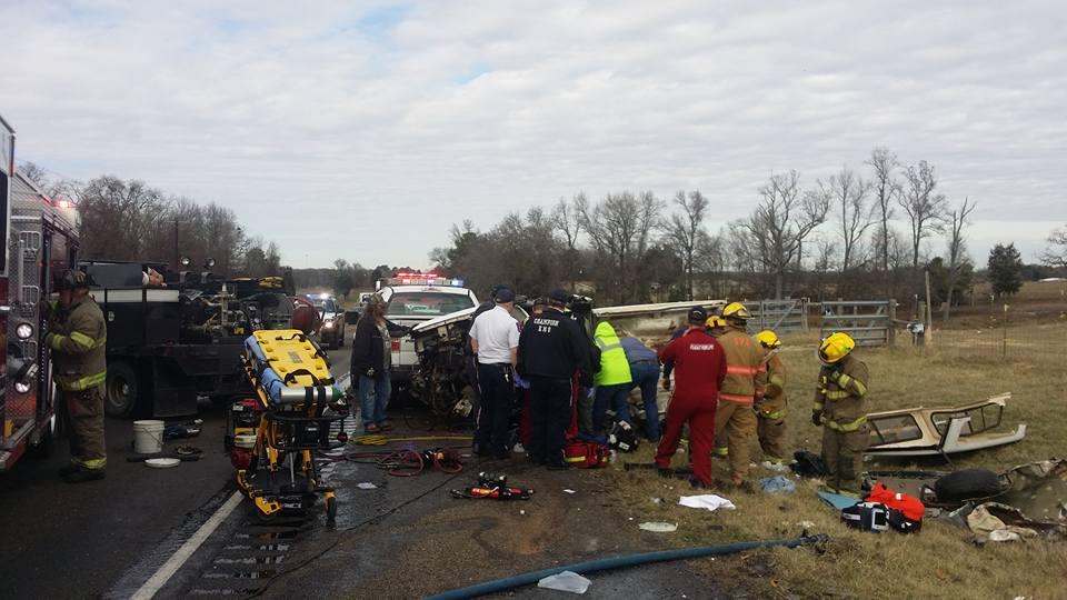 Damage done to a small pickup truck after a head-on collision with a semi-truck