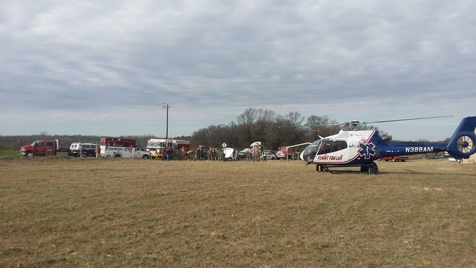 Damage done to a small pickup truck after a head-on collision with a semi-truck