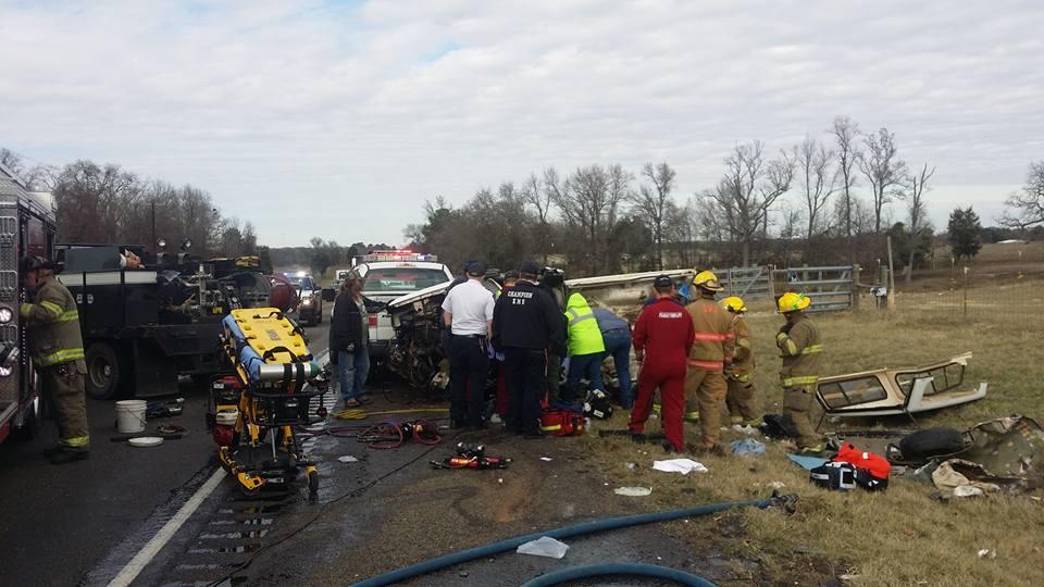 Damage done to a small pickup truck after a head-on collision with a semi-truck