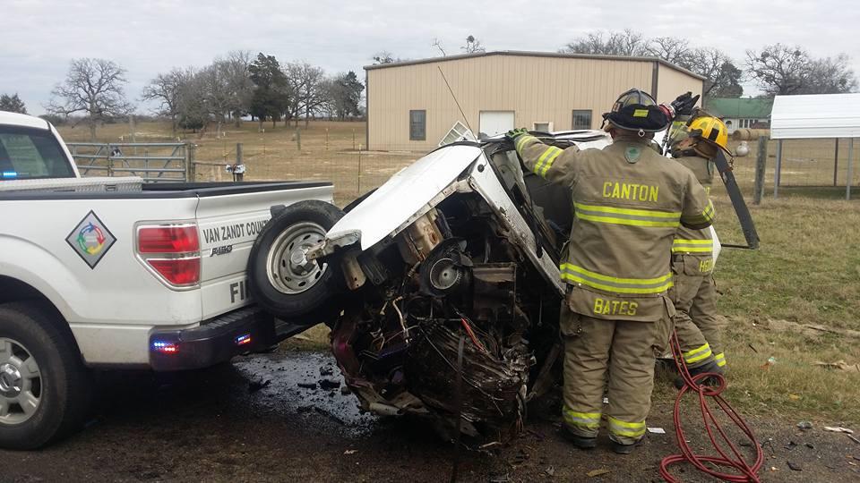 Damage done to a small pickup truck after a head-on collision with a semi-truck