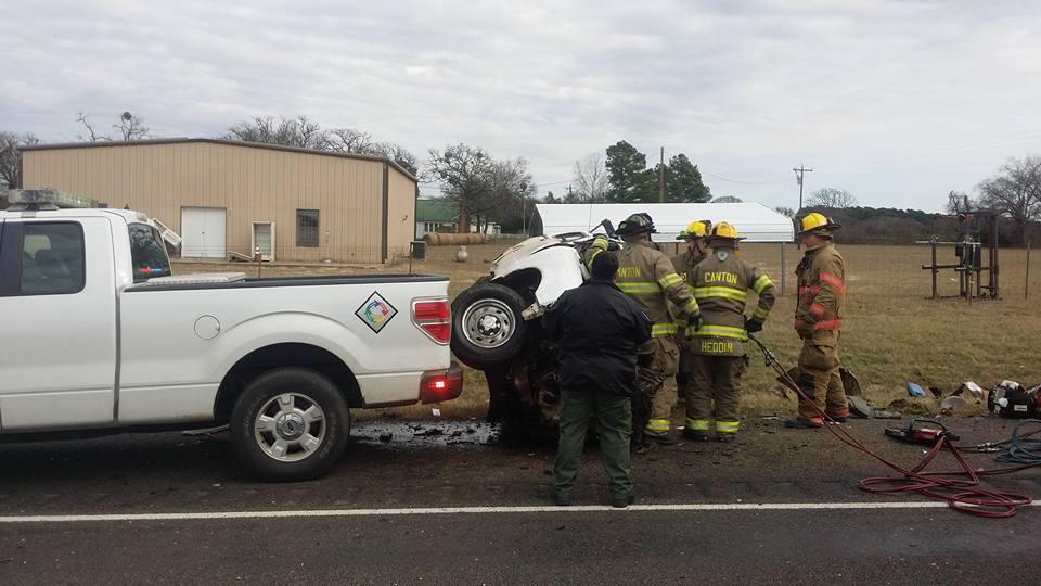 Damage done to a small pickup truck after a head-on collision with a semi-truck