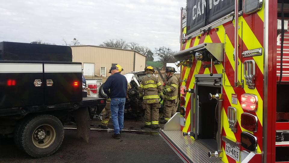 Damage done to a small pickup truck after a head-on collision with a semi-truck