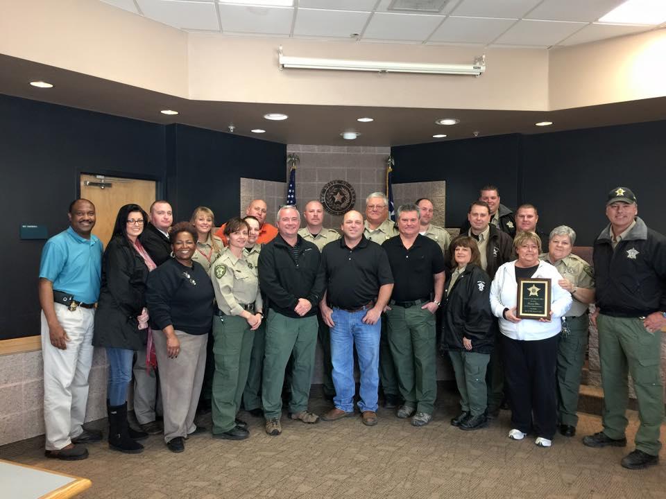 Tommie receives a plaque for her dedicated service to the NCSO