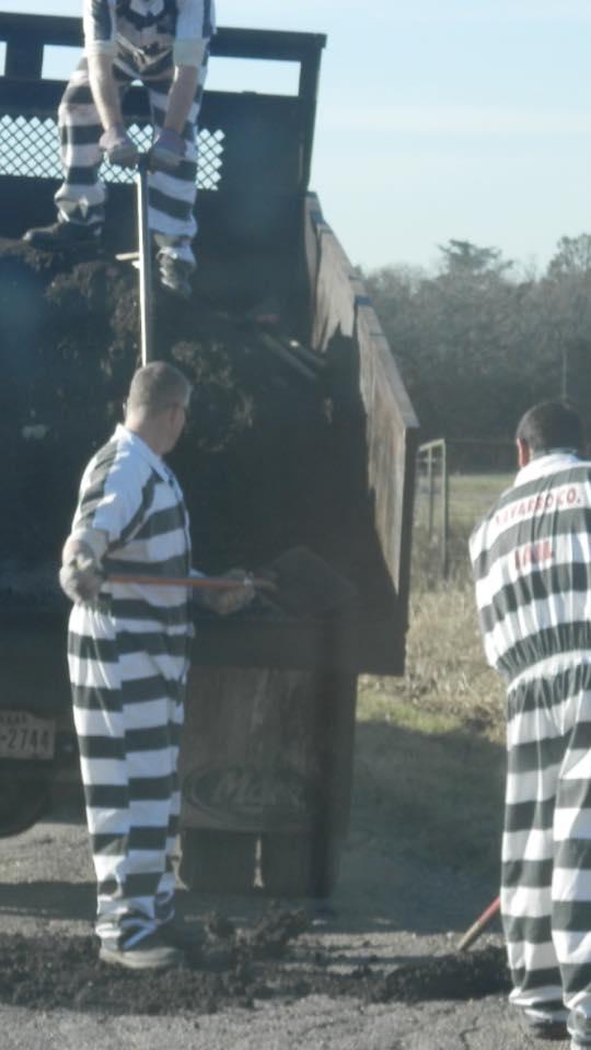 Inmates helping to repair the roadways