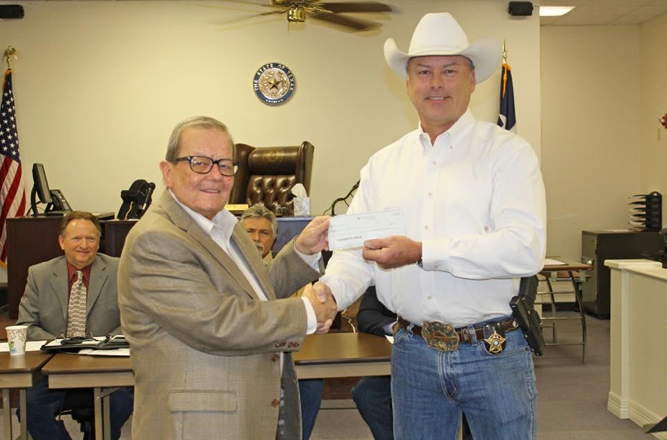 Sheriff Tanner receiving a check from Don Parks and the Chase Parks Foundation
