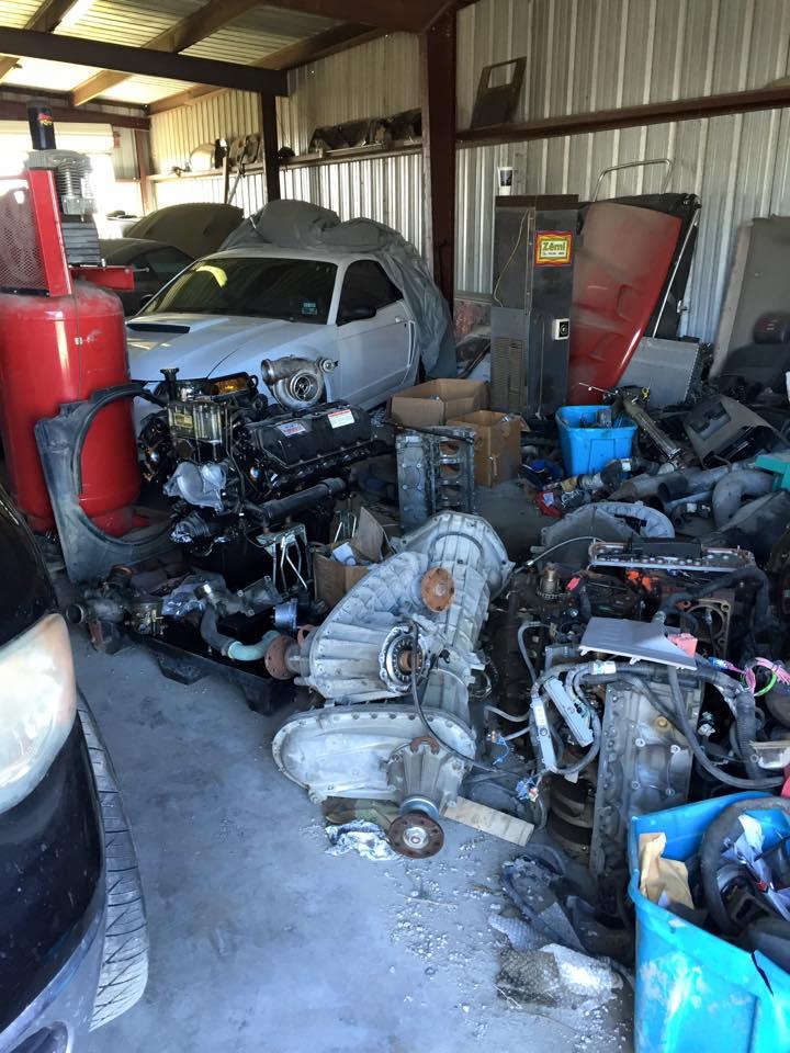 Vehicles and parts in a garage