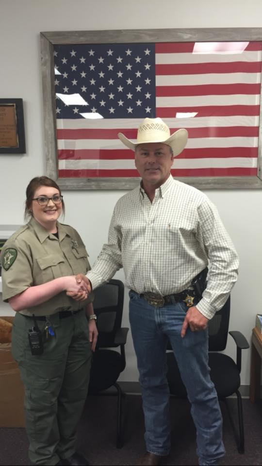 Heather Conley shaking hands with Sheriff Tanner