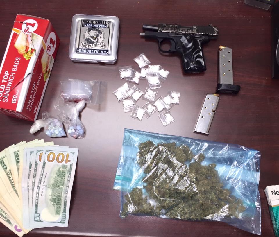 Cocaine, ecstasy, marijuana, cash, loaded Sig Sauer pistol, digital scales and empty baggies 