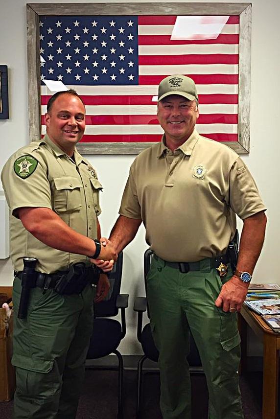 Eric Wilson shakes hands with Sheriff Tanner