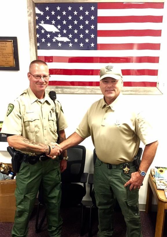 Randy Nanny shaking hands with Sheriff Tanner