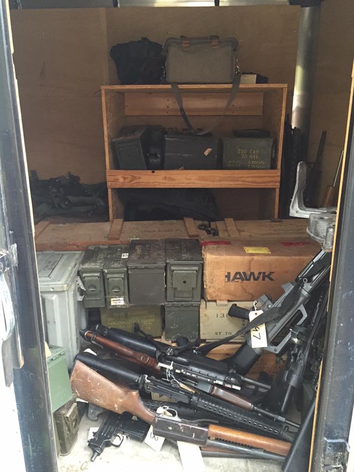 Multiple firearms and ammunition boxes
